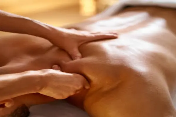Male massage therapist giving pain relief therapy at home in Varanasi